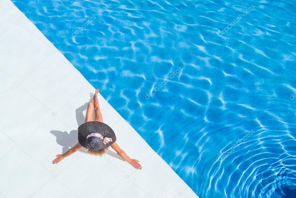 beautiful tanned sporty slim woman relaxing in swimming