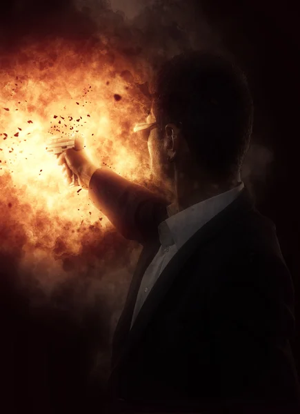 Man with a gun on explosion background — Stock Photo, Image