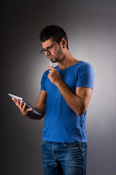 young male executive using digital tablet