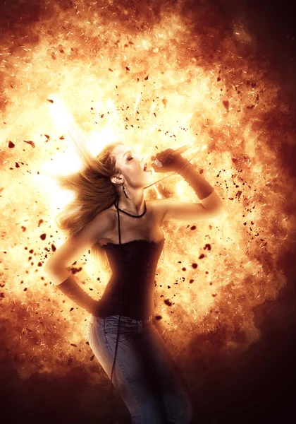 Female rock singer over blazing explosion — Stock Photo, Image