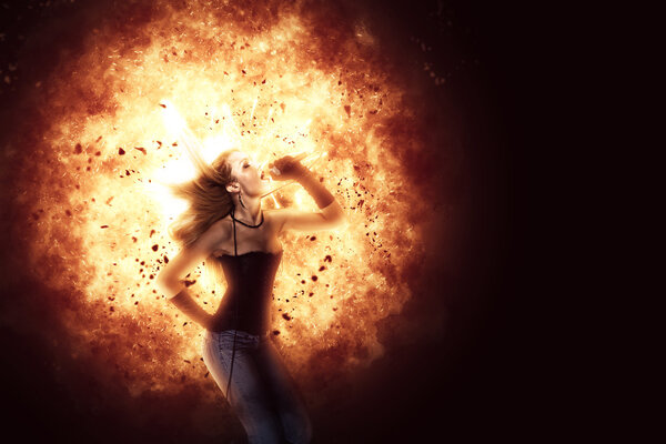 Female rock singer over blazing explosion background