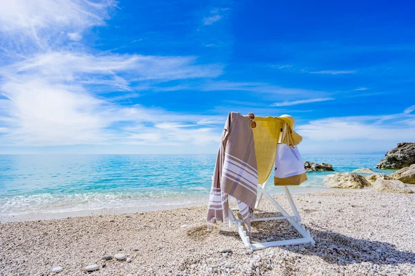 Beach with deck chair, towel, bag, hat — Stock Photo, Image