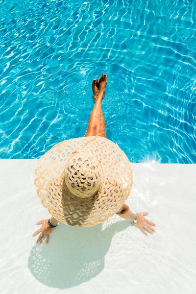 Женщина в шляпе у бассейна — стоковое фото