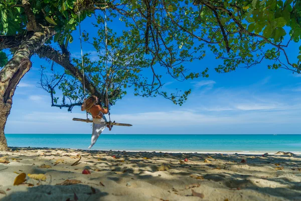 Woman swinging at the beach — Stock Photo, Image