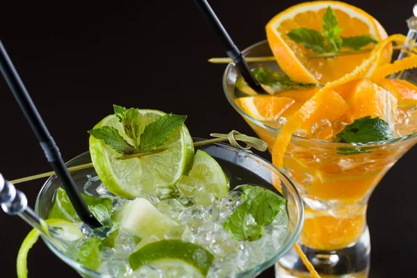 Orange and lime Mojito over black  background — Stock Photo, Image