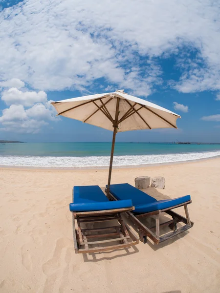 Soffa fåtöljer med parasoll på stranden — Stockfoto