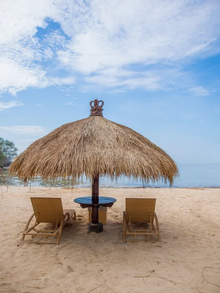 Liegestühle mit Sonnenschirm am weißen Sandstrand — Stockfoto