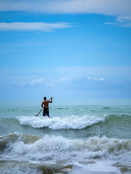 Man Stand up paddle surfing in Thailand Stock Photo