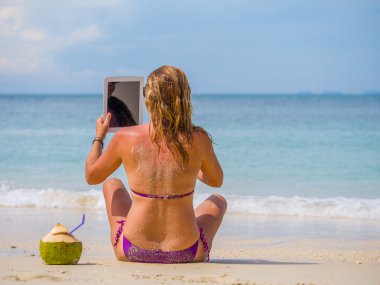 Tayland sahilde kadınla onun tablet kullanma