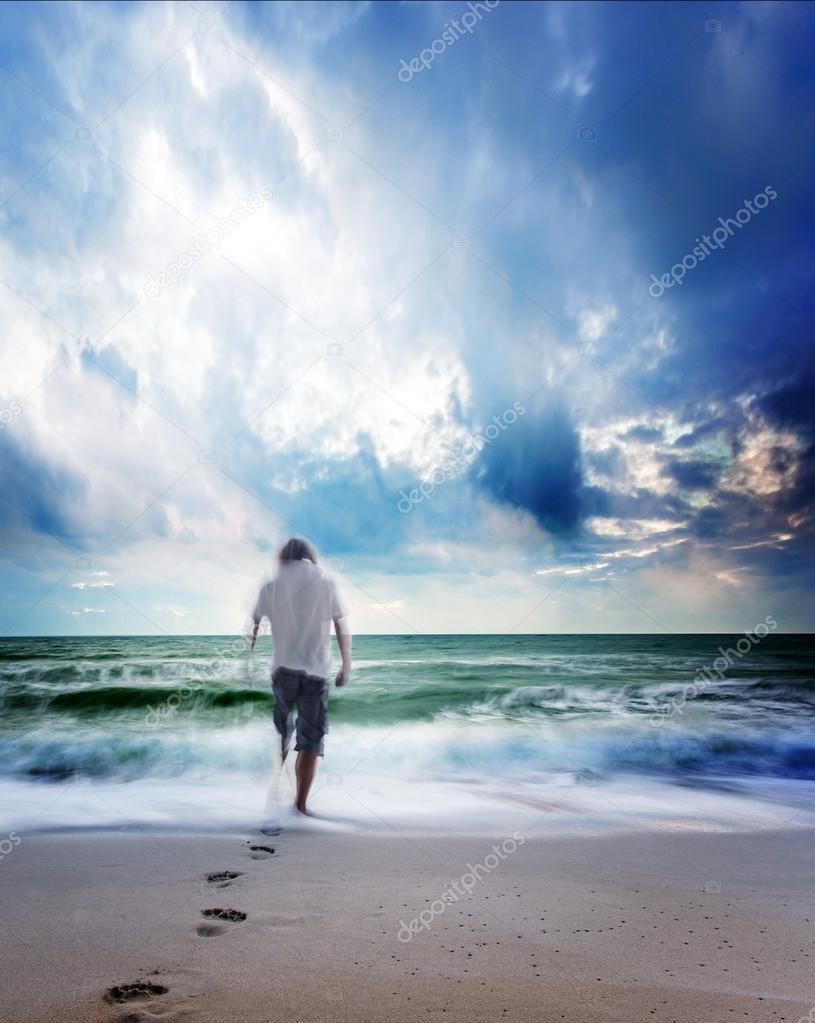 Man walking on the beach leaving footprints