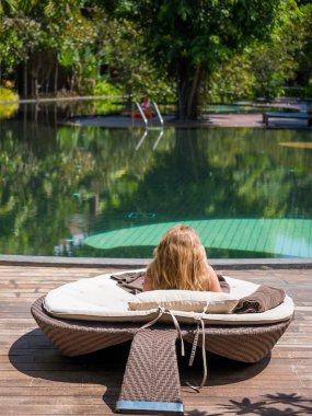  Yüzme havuzunun kenarında oturan kız