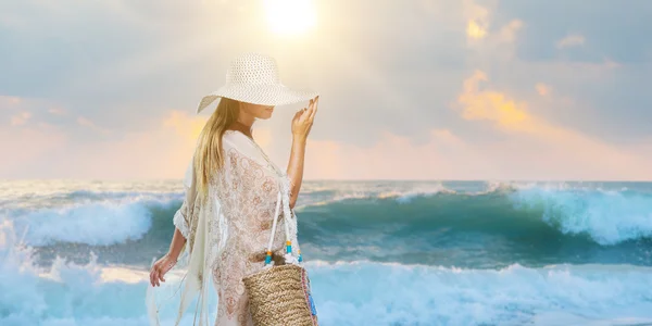 Kvinna elegant promenerar på stranden — Stockfoto