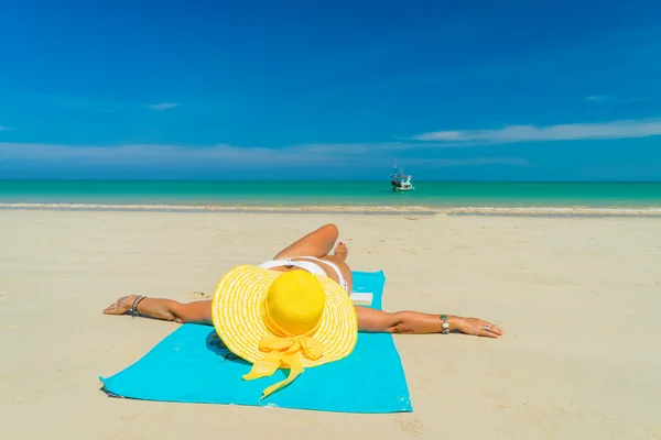 Kadın sarı bikini tropik sahilde yalan — Stok fotoğraf