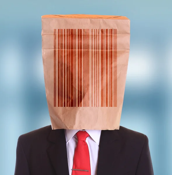 Man papieren zak op kop met barcode symbool — Stockfoto