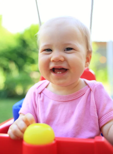 Cute child smiling in swing — Stock Photo, Image