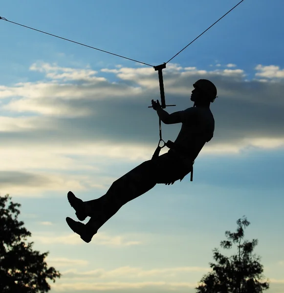 Silhouette of alpinist hang on rope — Stock Photo, Image