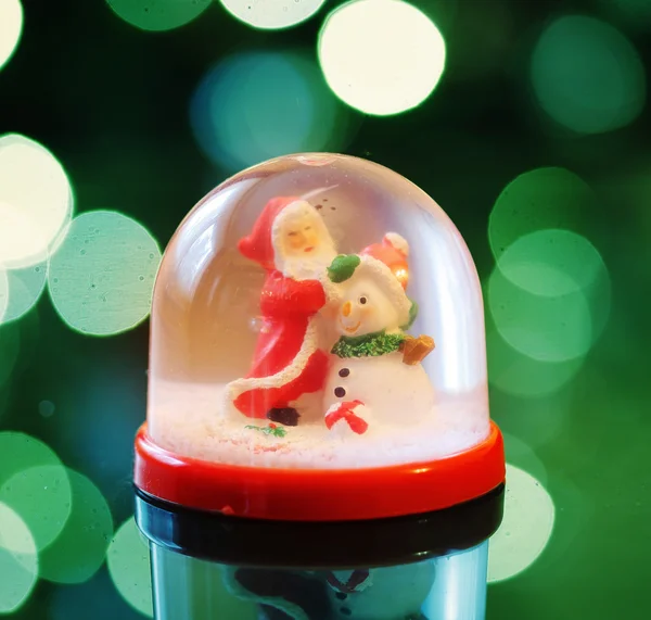 Snowing dome with green abstract background at christmas — Stock Photo, Image