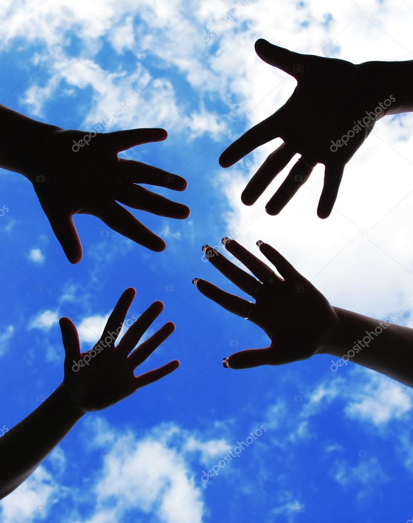Five hands symbol of union touch against sky