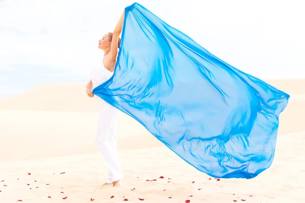 Young woman with flying blue scarf — Stock Photo, Image