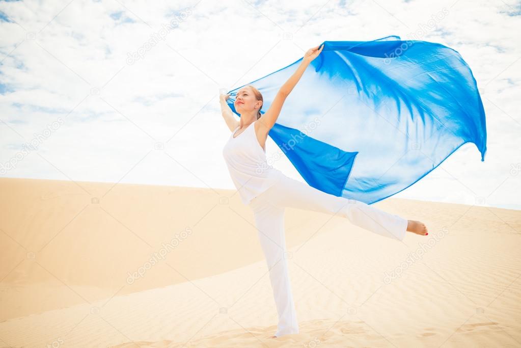 Young woman with flying blue scarf