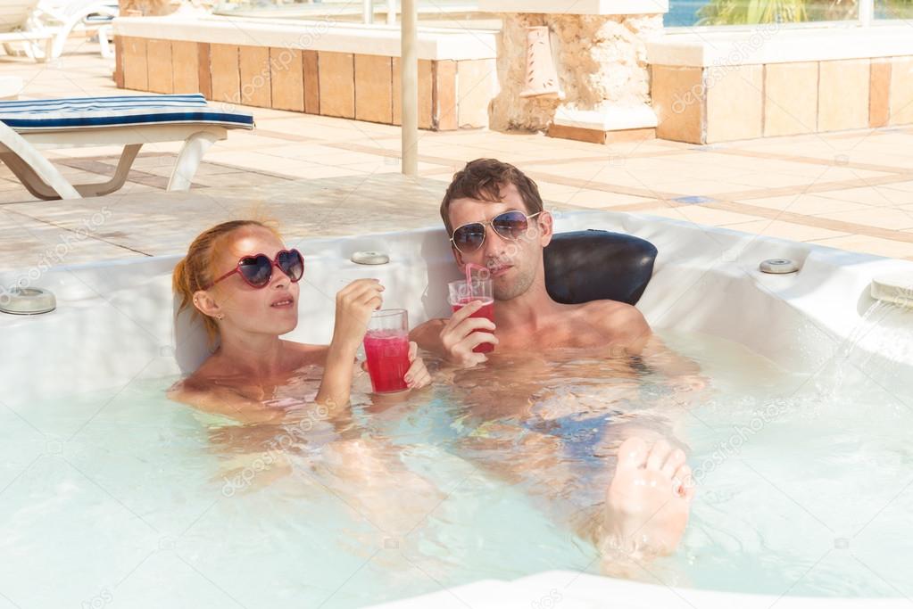 Young couple relaxing in jacuzzi pool