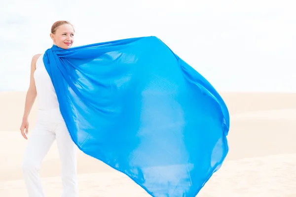 Young woman with flying blue scarf — Stock Photo, Image