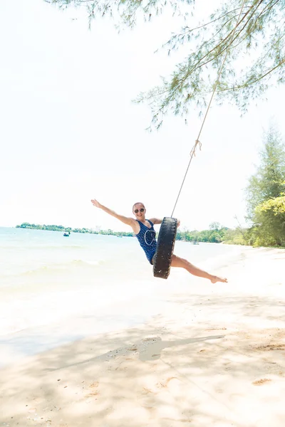 Happy woman on tire swing — Stock Photo, Image