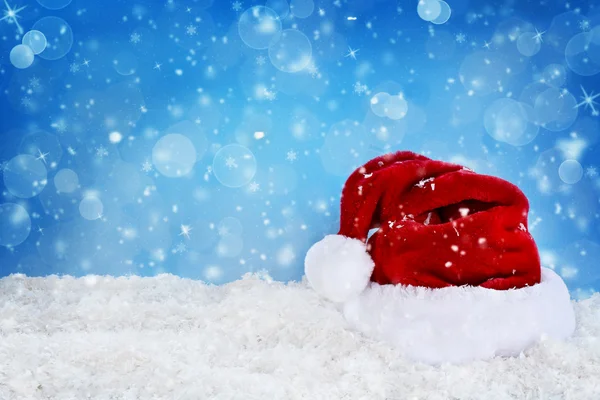 Santa hat against blue background — Stock Photo, Image