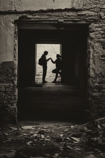 Silhuetas de menino e menina encontrando segredo no prédio abandonado — Fotografia de Stock