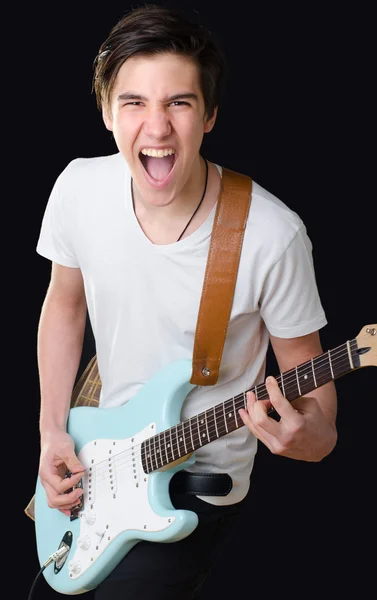 Teenage boy playing electric guitar and singing — Stock Photo, Image