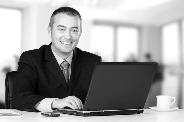 Young happy businessman working in his office — Stock Photo, Image