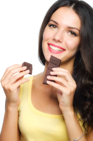 Beautiful smiling girl holding and eating chocolate isolated on white — Stock Photo, Image