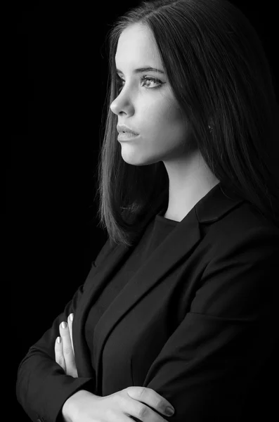 Portrait of beautiful young business woman isolated on black background