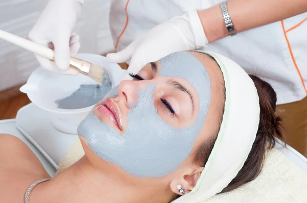 Young woman with natural facial mask — Stock Photo, Image