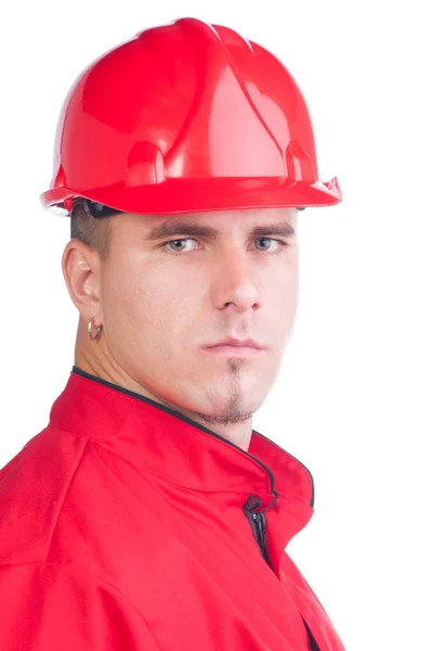 Jovem mecânico bonito com chapéu duro e ferramentas e em macacão — Fotografia de Stock