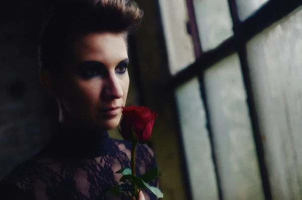 Beautiful elegant lady holding red rose — Stock Photo, Image