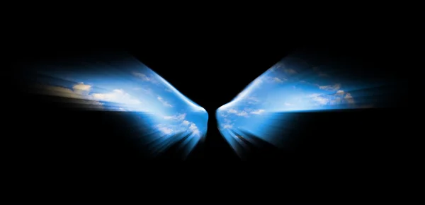 Angel wings isolated on black background and blue sky is visible — Stock Photo, Image