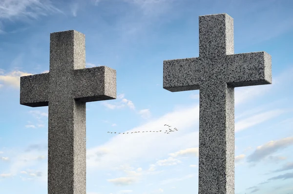 Two concrete crosses against sky and trees — Stock Photo, Image