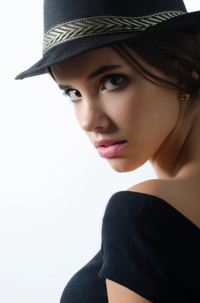 Portrait of beautiful brunette girl in black hat and black sweater — Stock Photo, Image