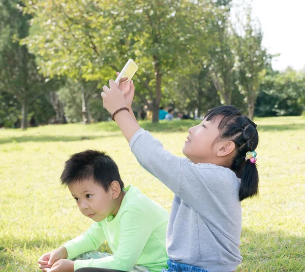 Girl and a boy in the grass — Stock Photo, Image