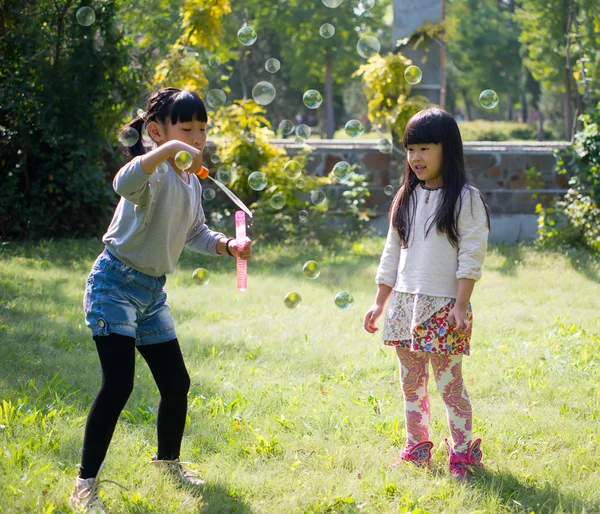 Children blowing soap bubbles — Stock Photo, Image