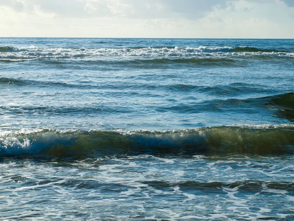 Onde oceaniche che si infrangono sulla spiaggia in una giornata limpida — Foto Stock