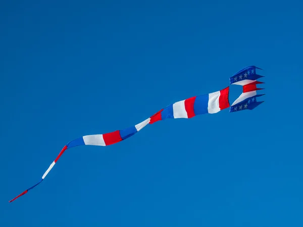 Red, White, and Blue Kite Flying in Cloudless Blue Sky — Stock Photo, Image