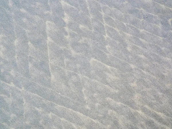 Padrões de areia coloridos criados por ondas e vento — Fotografia de Stock