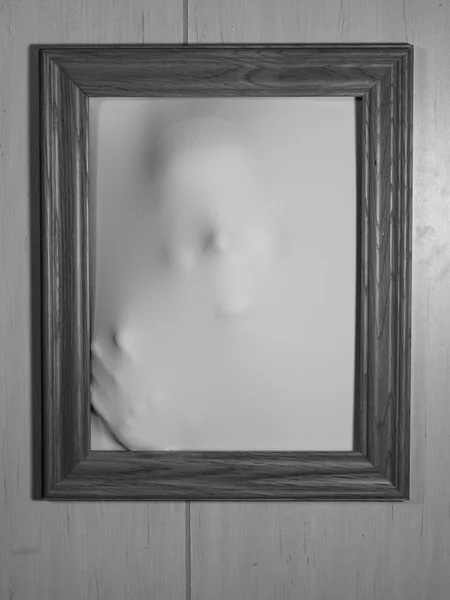 Creepy Picture Frame with Something Coming Out of It