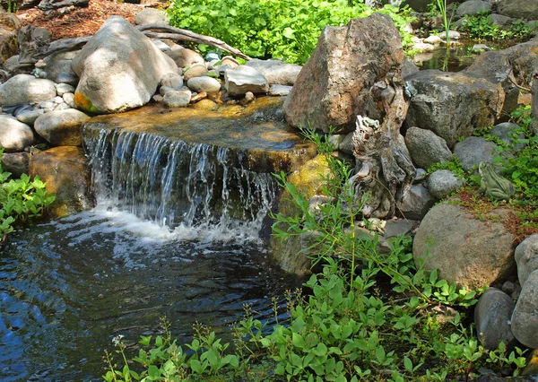 Beautiful Pond and with a Small, Rocky Waterfall — Stock Photo, Image