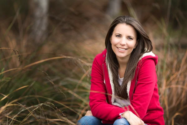 Belle femme souriante dans l'herbe — Photo