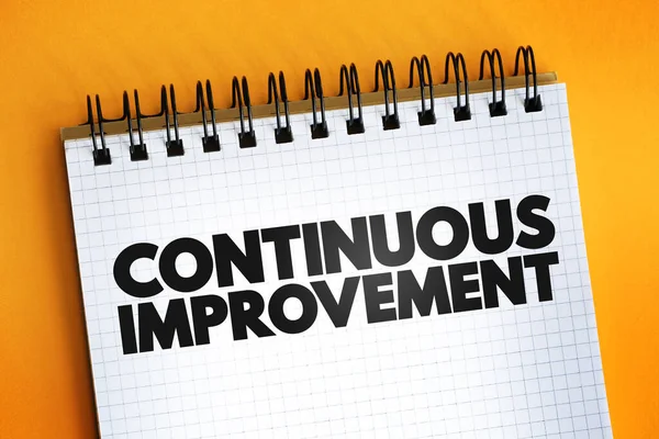 Continuous Improvement text on notepad, business concept background