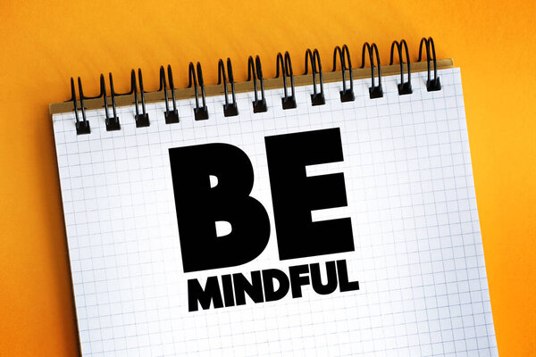 Be Mindful text quote on notepad, concept backgroun