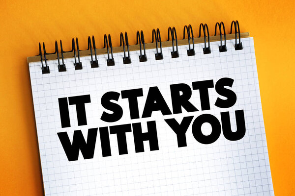 It Starts With You text quote on notepad, concept backgroun